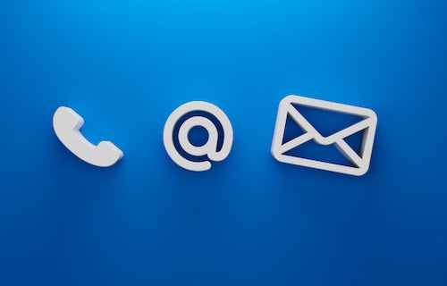 White icons of a phone, an @ symbol, and an envelope on a blue background, representing contact options.